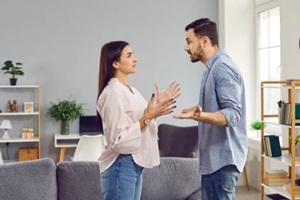 emotional stressed young couple having argument at home