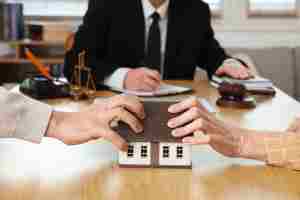 Mature couple dividing house at divorce lawyer's office, closeup