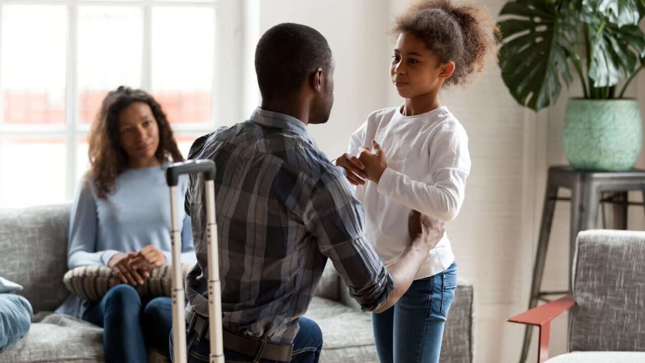 african american father talking to upset mixed race kid daughter saying goodbye to sad preschool girl before leaving family with suitcase