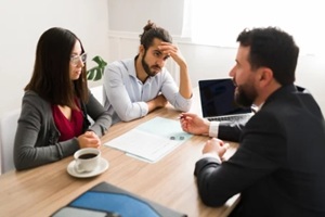 divorce attorney talking to an angry couple