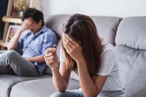 frustrated sad wife taking off the wedding ring