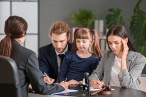 young couple and their daughter visiting divorce lawyer in office