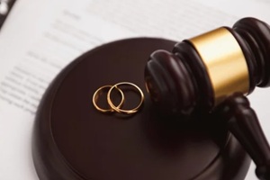 divorce concept with gavel and wedding rings