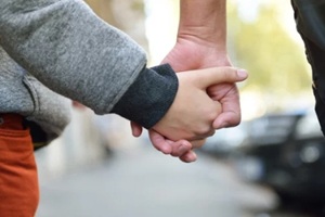 hands of mother and child outdoor closeup