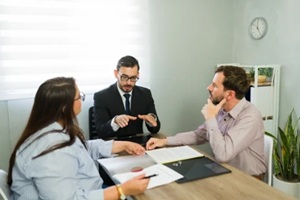 lawyer conciliating couple discussing divorce agreement paperwork