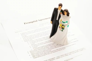 cake-topper wedding couple and a pre-nuptial agreement