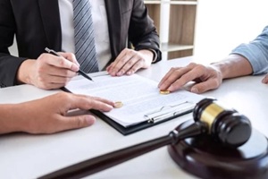 couple signing divorce agreement with lawyer