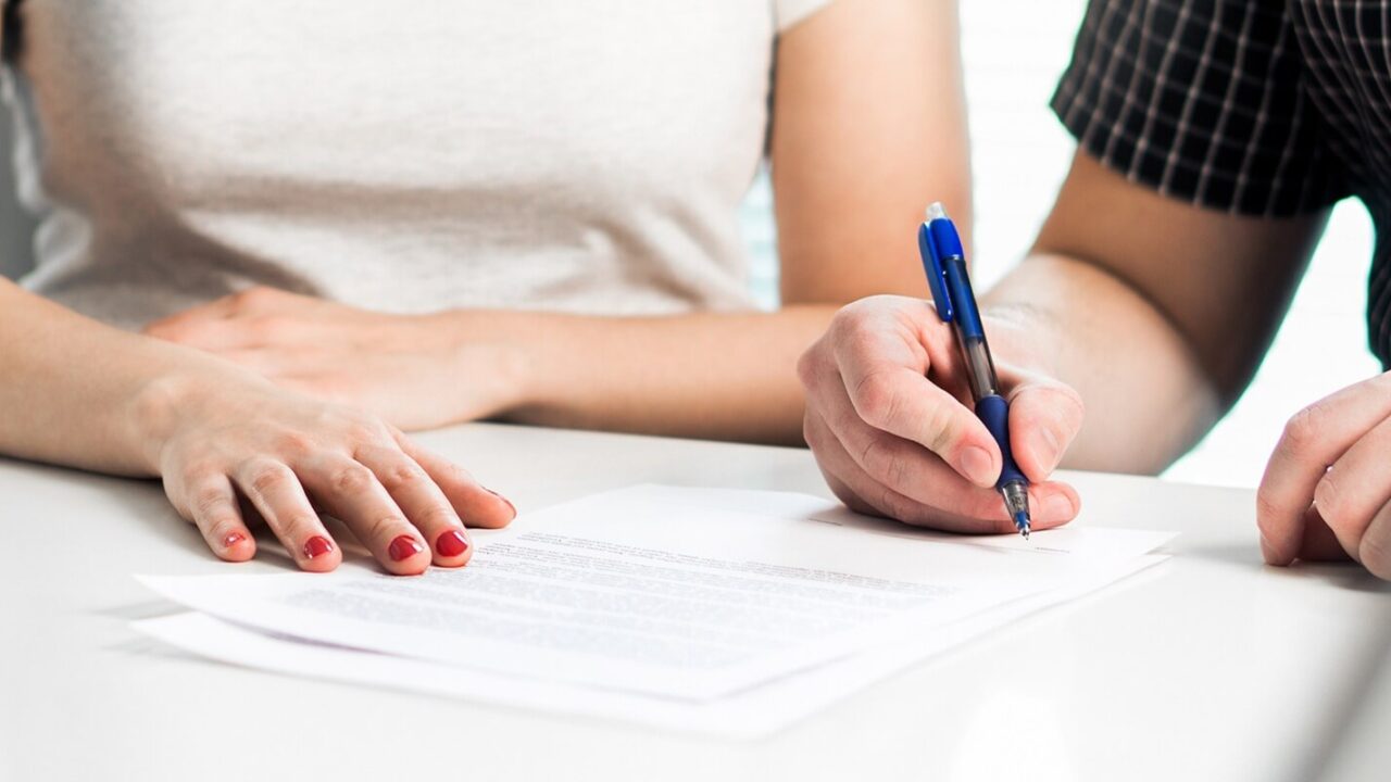 divorce agreement, couple signing legal document
