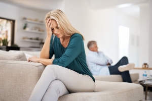 Stressed Woman Sitting on Sofa After Knowing Her Spouse Filed a Divorce