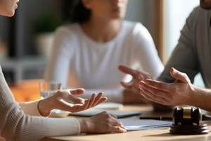 couple arguing in a lawyer's office during a divorce consultation, legal dispute, marriage separation