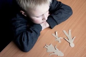 confused child with broken paper family