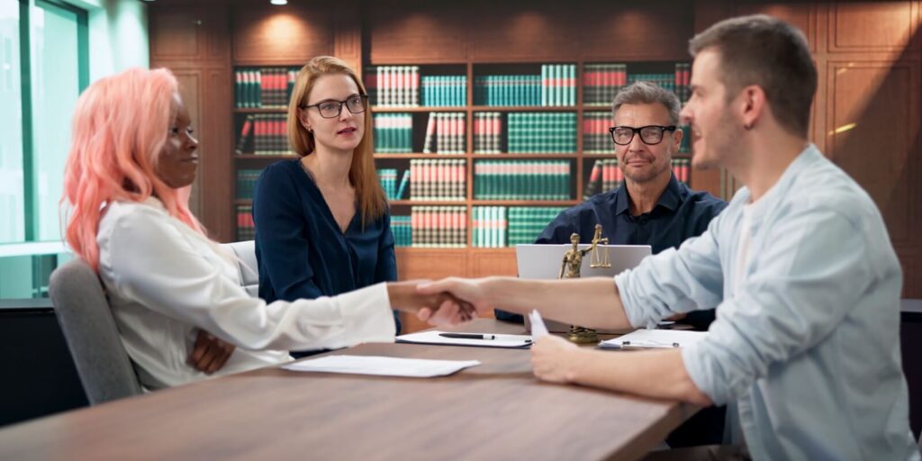 divorce mediator finalizes peaceful agreement as couple shakes