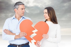 mature couple holding a broken heart